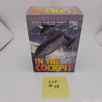 Front view of the DVD slipcase titled 'In the Cockpit' featuring an image of a military aircraft flying over mountainous terrain.
