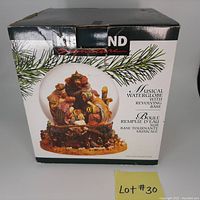 Box showing Kirkland signature, image of nativity scene water globe, musical water globe with revolving base wording