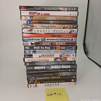 Stack of 20 assorted DVD and Blu-ray movies in cases, titles visible and identifiable.