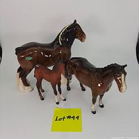 All three Beswick horse figurines: matte bay foal, glossy bay Huntsman's horse, and glossy bay Shire horse with Beswick sticker.