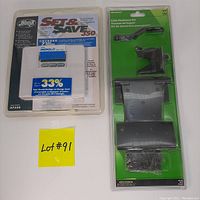 Photo showing unopened Hillman gate hardware kit and Hunter Set & Save 350 thermostat package with yellow lot number card.