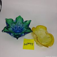 Lot of two Murano-style glass bowls: one blue and green with ruffled edges, one yellow with silver flecks in organic shape.