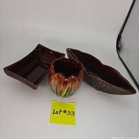 All three items in the lot: two pottery planters and one tulip vase, arranged on a white background with the lot number visible