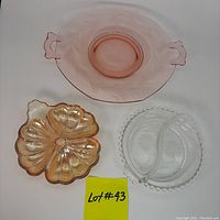 Top-down photo showing three vintage glass serving pieces: pink cake plate, clear divided dish, and gold clover-shaped candy dish with a label 'Lot #43'.