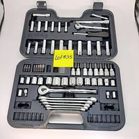 Open view of complete socket wrench set showing ratchets, sockets, bits, extensions, and wrenches in molded black plastic case