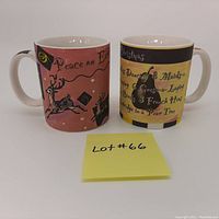 Front and side views of the yellow and purple Starbucks Christmas mugs with Lot #66 note in front