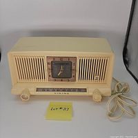 Front view of the vintage Viking cream plastic electric clock radio showing the entire unit including power cord, tuning knobs, and clock face.