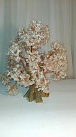 Full view of the large crystal quartz tree standing upright with copper wire branches and clear quartz chips attached.