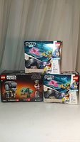 Photo showing all three unopened LEGO sets: one Star Wars BrickHeadz 75317 and two Hidden Side 40408 sets.