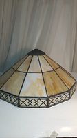 Front and side view of slag glass lamp shade topper showing glass panels and metal edging
