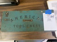 Top-down view of chest lid showing “AMERICAN TOOL CHEST” stenciled lettering and center handle