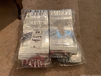 Photo showing 8 unopened packages of identical zip-lock shipping bags stacked together in plastic wrapping.