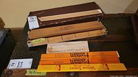 Wooden V-Master cigarette roller with original box and branded rulers/paper strips.