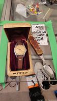Full view of wristwatch in original Westfield box and the wooden-handled spork beside it.