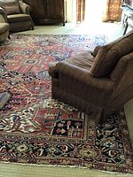 Large carpet laid in living room beneath seating to show overall scale and design