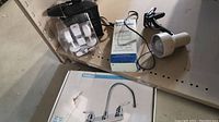 Photo of Peerless kitchen faucet in box with some damage.