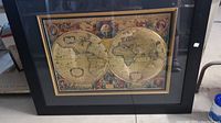 Framed vintage style world map print with dual-hemisphere antique map illustration and decorative details