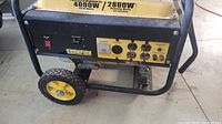 Front and side view showing metal frame, wheels, control panel, Champion label and yellow fuel tank