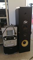 Lot showing full view of Curtis karaoke machine with CRT monitor and two KLH REF. 18 black wooden speakers side by side.