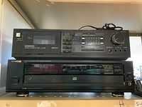 Top photo shows two stacked Kenwood stereo devices: the top one is the stereo cassette deck KX-328 with its interface and controls visible; the bottom one is the multiple compact disc player DP-R4420 with the disc tray visible.