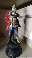 Full view of the painted knight figurine standing on base, showing colors and pose