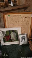 Lot of three framed works: an old map with wooden frame, still life oil painting in white frame, and black and white horse head print signed by Al. J. Casson.