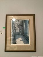 Framed print hanging on wall, showing full image and frame