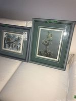 Wide shot of both framed prints on white sofa