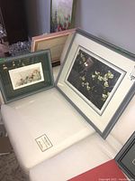 Both framed Robert Bateman prints displayed on a white surface