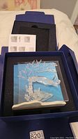 Full view of Swarovski coral reef figurine in original box with foam padding and instruction sheet.