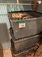 Stacked clear Rubbermaid storage bins with lids, containing the mason jars as indicated by seller title and description.