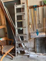 Full view of the aluminum folding ladder with six steps, showing overall condition and structure.