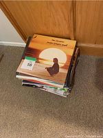 Stack of vinyl record albums with Neil Diamond album visible on top.