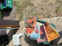 Close-up showing several vintage Playboy magazine covers with different women featured on front, placed on top of the container.