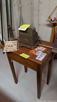 Baia 8mm metal movie film editor on wooden table with instruction manuals scattered around