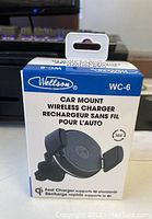 Front of the retail box showing the product name, brand Wellson WC-6, and image of the car mount wireless charger with air vent clip.