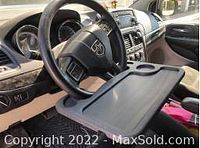 Photo of the black steering wheel desk mounted onto a car steering wheel showing size and fit