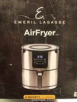 Front view of the retail box showing the Emeril Lagasse AirFryer in stainless steel with digital display and 4 quart capacity.