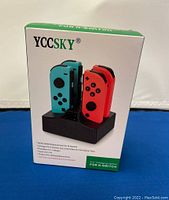 Boxed product showing YCCSKY branding and photo of charging station with Joy-Con controllers.