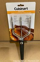 Front view of Cuisinart Turkey Lifters in original packaging showing brand, model, and features like soft grip handles, stainless steel prongs, and dishwasher safe.