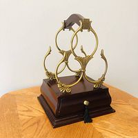 Front view showing wood base with drawer, brass wine holder rack above