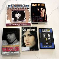 Five books about Jim Morrison and The Doors displayed on a light surface, titles and authors visible.