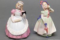 Front and side view of Babie and Cookie Royal Doulton porcelain figurines showing details and condition
