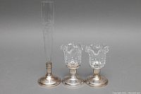 Full view of vintage crystal bud vase and two hobnail crystal candleholders with silver bases.