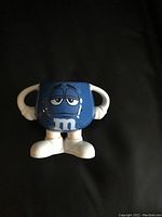 Top view showing Blue M&M character design with arms, white shoes, and M logo on front