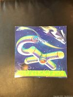 Front cover of Blue Öyster Cult "Club Ninja" vinyl LP showing sci-fi spaceship artwork and bold yellow-green band name lettering at bottom.