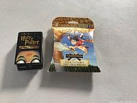 Front view showing sealed Harry Potter Quidditch Card Game box and a stack of Harry Potter Wizard Cards