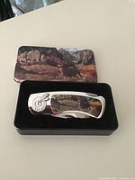 Pocket tool with original decorative box showing outdoors scene with deer.