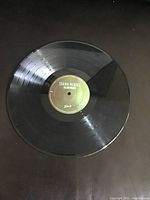 Photo of Side A of Shawn Mendes Illuminate vinyl LP record, black with green label.