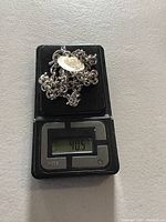 Necklace chain coiled on digital scale showing 40.5g weight